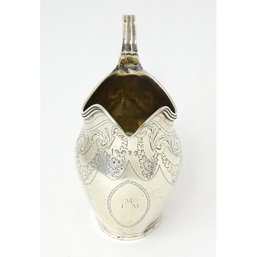 342 - A silver cream jug with engraved decoration, hallmarked London 1802, maker Peter, Ann & William Bate... 