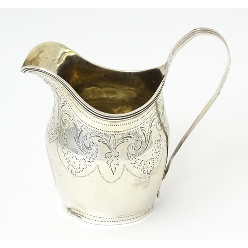342 - A silver cream jug with engraved decoration, hallmarked London 1802, maker Peter, Ann & William Bate... 