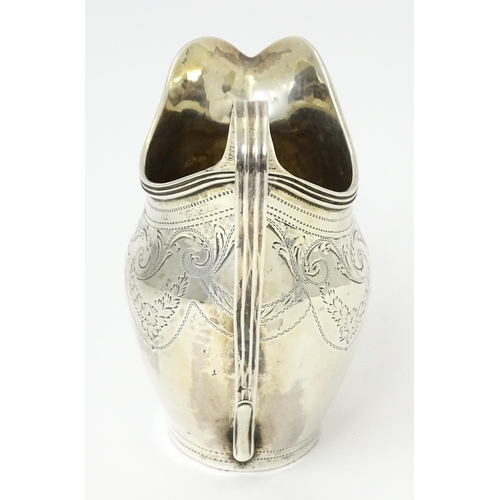 342 - A silver cream jug with engraved decoration, hallmarked London 1802, maker Peter, Ann & William Bate... 