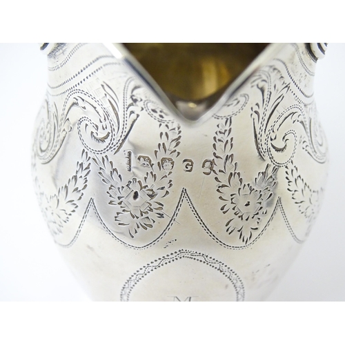 342 - A silver cream jug with engraved decoration, hallmarked London 1802, maker Peter, Ann & William Bate... 
