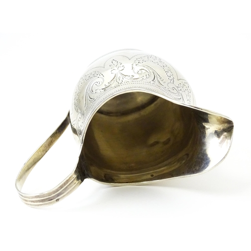 342 - A silver cream jug with engraved decoration, hallmarked London 1802, maker Peter, Ann & William Bate... 