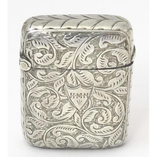 349 - A silver vesta case with engraved acanthus scroll decoration, hallmarked Birmingham 1897, maker JT. ... 