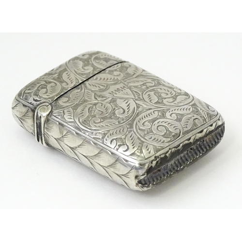 349 - A silver vesta case with engraved acanthus scroll decoration, hallmarked Birmingham 1897, maker JT. ... 