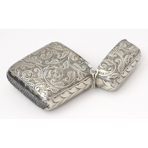 349 - A silver vesta case with engraved acanthus scroll decoration, hallmarked Birmingham 1897, maker JT. ... 