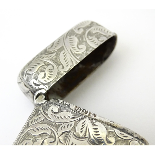 349 - A silver vesta case with engraved acanthus scroll decoration, hallmarked Birmingham 1897, maker JT. ... 