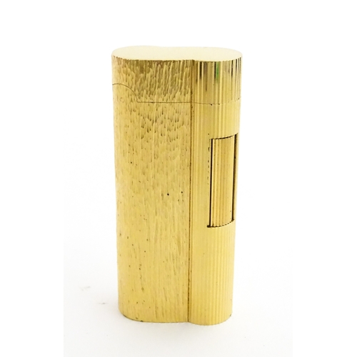 1191 - A Dunhill S-type pocket lighter with linear and hammered decoration. The base stamped with serial nu... 