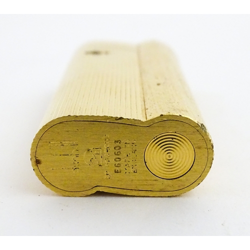 1191 - A Dunhill S-type pocket lighter with linear and hammered decoration. The base stamped with serial nu... 