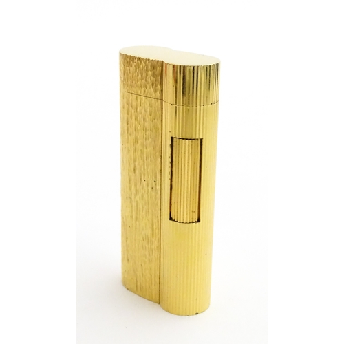 1191 - A Dunhill S-type pocket lighter with linear and hammered decoration. The base stamped with serial nu... 