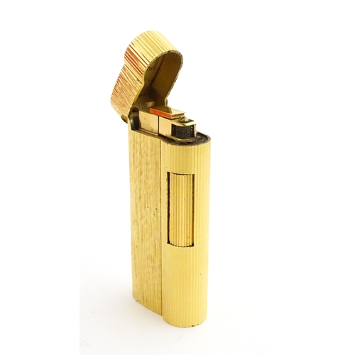 1191 - A Dunhill S-type pocket lighter with linear and hammered decoration. The base stamped with serial nu... 