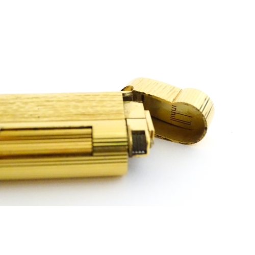 1191 - A Dunhill S-type pocket lighter with linear and hammered decoration. The base stamped with serial nu... 