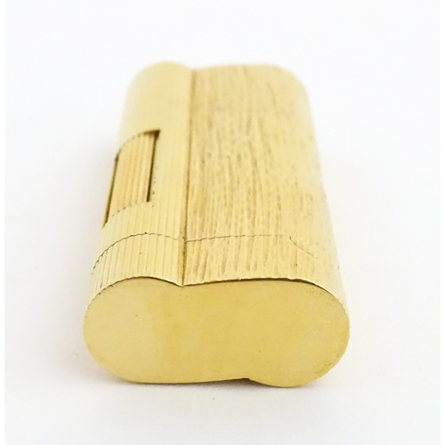 1191 - A Dunhill S-type pocket lighter with linear and hammered decoration. The base stamped with serial nu... 