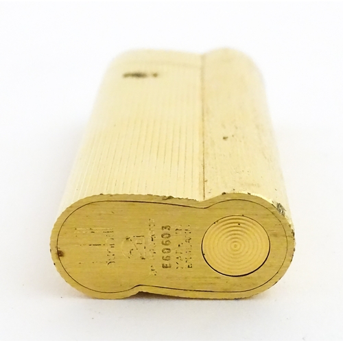 1191 - A Dunhill S-type pocket lighter with linear and hammered decoration. The base stamped with serial nu... 