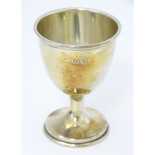 528 - A cased silver Christening set comprising egg cup, spoon and napkin ring, hallmarked Birmingham 1922... 