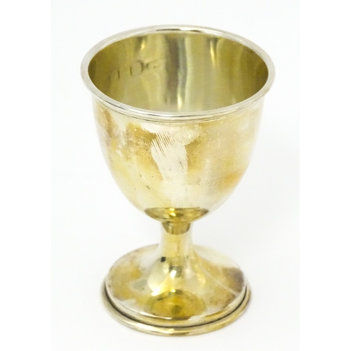 528 - A cased silver Christening set comprising egg cup, spoon and napkin ring, hallmarked Birmingham 1922... 