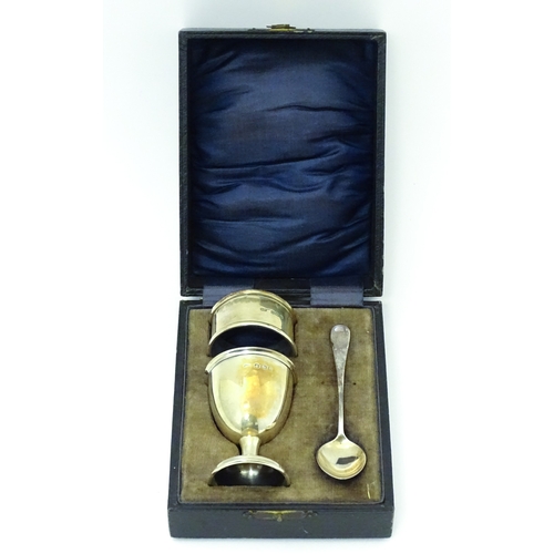 528 - A cased silver Christening set comprising egg cup, spoon and napkin ring, hallmarked Birmingham 1922... 
