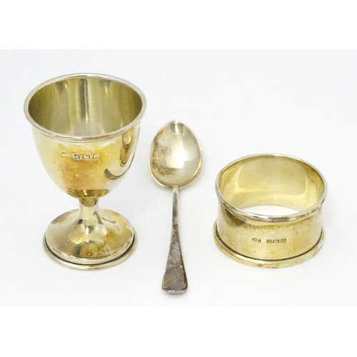 528 - A cased silver Christening set comprising egg cup, spoon and napkin ring, hallmarked Birmingham 1922... 