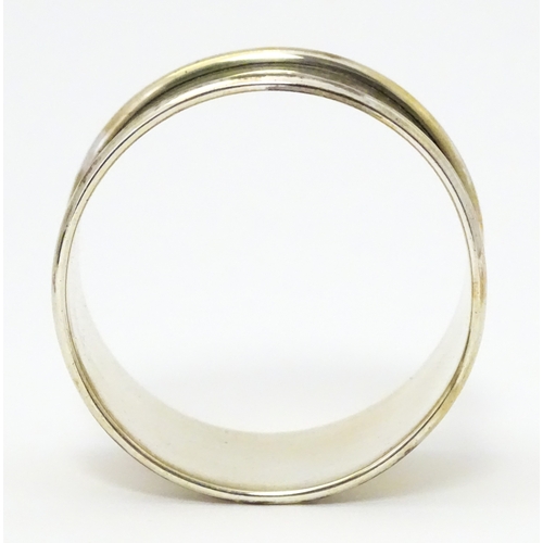 528 - A cased silver Christening set comprising egg cup, spoon and napkin ring, hallmarked Birmingham 1922... 