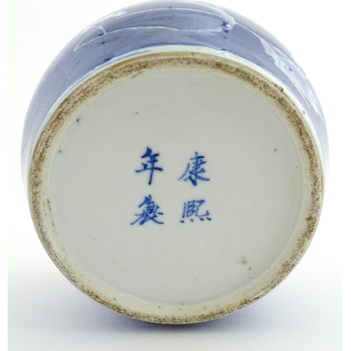 58 - A Chinese blue and white vase / jar decorated with blossom. Character marks under. Approx. 5 1/2