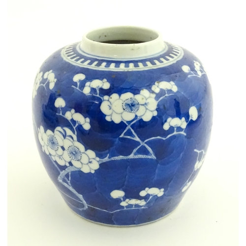58 - A Chinese blue and white vase / jar decorated with blossom. Character marks under. Approx. 5 1/2