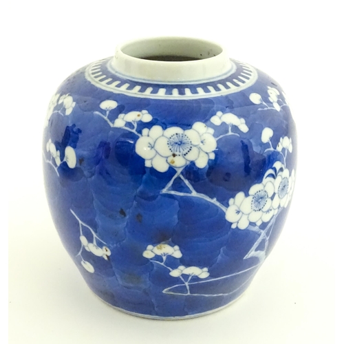58 - A Chinese blue and white vase / jar decorated with blossom. Character marks under. Approx. 5 1/2