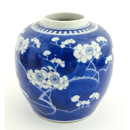 58 - A Chinese blue and white vase / jar decorated with blossom. Character marks under. Approx. 5 1/2