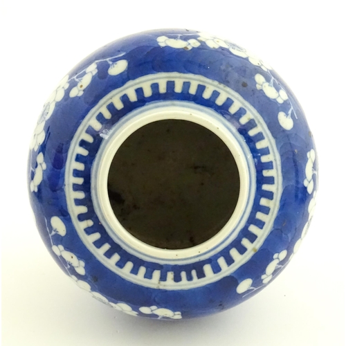 58 - A Chinese blue and white vase / jar decorated with blossom. Character marks under. Approx. 5 1/2