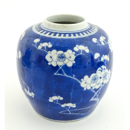 58 - A Chinese blue and white vase / jar decorated with blossom. Character marks under. Approx. 5 1/2