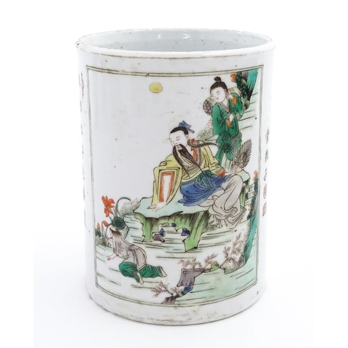 60 - A Chinese Wucai brush pot decorated with figures on a terrace, and in a landscape, with Character sc... 