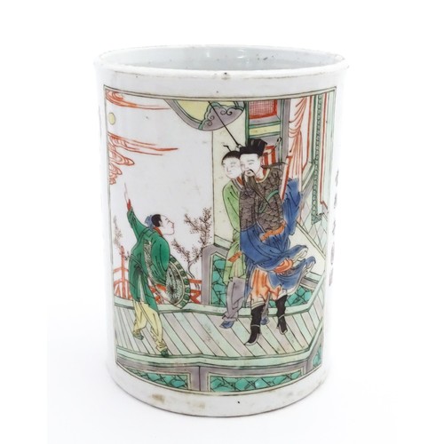 60 - A Chinese Wucai brush pot decorated with figures on a terrace, and in a landscape, with Character sc... 