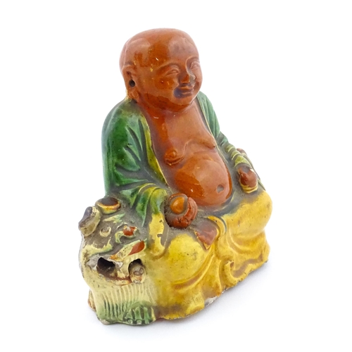 63 - A Chinese Sancai style model of a laughing Buddha. Approx. 4 1/2