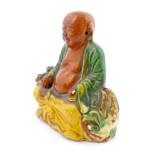 63 - A Chinese Sancai style model of a laughing Buddha. Approx. 4 1/2