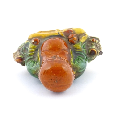 63 - A Chinese Sancai style model of a laughing Buddha. Approx. 4 1/2