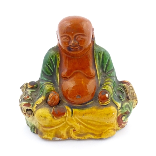 63 - A Chinese Sancai style model of a laughing Buddha. Approx. 4 1/2