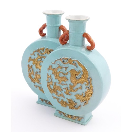 64 - A Chinese double moon vase with relief gilt detail. Character marks under. Approx. 6 1/2
