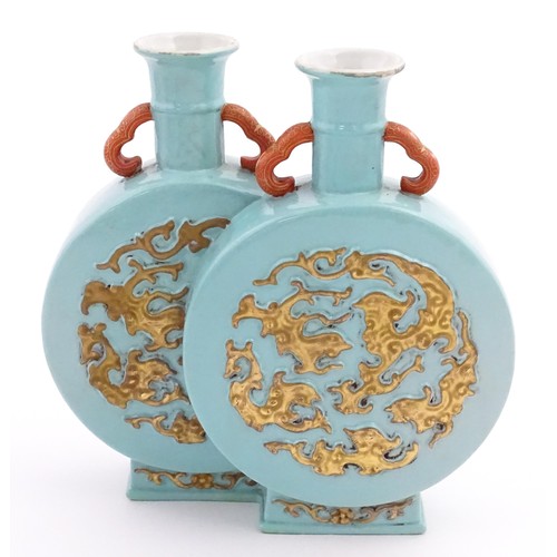 64 - A Chinese double moon vase with relief gilt detail. Character marks under. Approx. 6 1/2