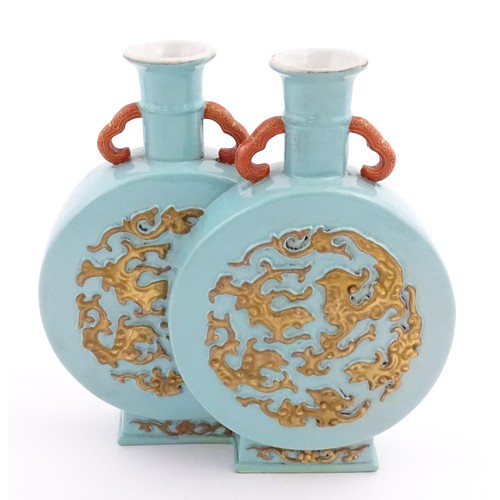 64 - A Chinese double moon vase with relief gilt detail. Character marks under. Approx. 6 1/2