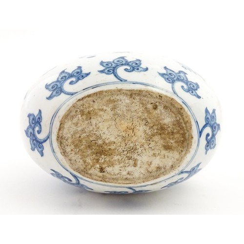 65 - A Chinese blue and white twin handled moon vase decorated with a bird perched on a branch. Approx. 9... 