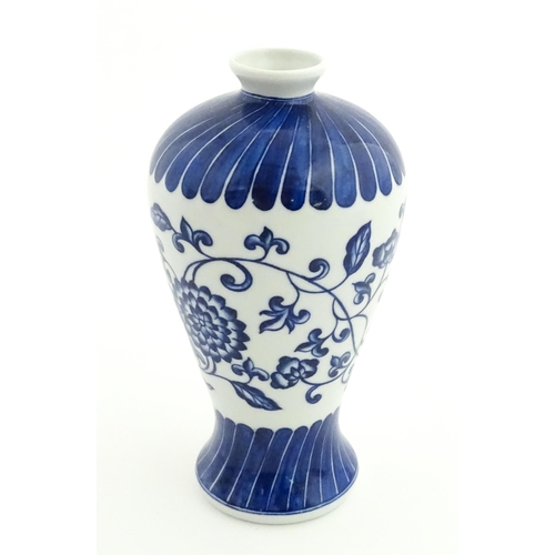 66 - A Chinese blue and white vase decorated with flowers an foliage. Character marks under. Approx. 7 3/... 