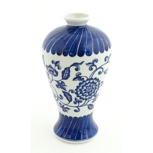66 - A Chinese blue and white vase decorated with flowers an foliage. Character marks under. Approx. 7 3/... 