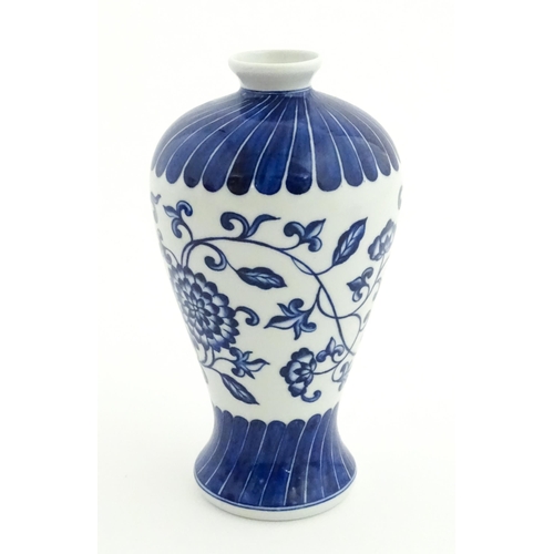 66 - A Chinese blue and white vase decorated with flowers an foliage. Character marks under. Approx. 7 3/... 