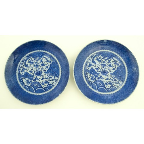 72 - A pair of Chinese blue and white chargers decorated with dragons and a flaming pearl amongst stylise... 
