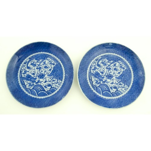 72 - A pair of Chinese blue and white chargers decorated with dragons and a flaming pearl amongst stylise... 