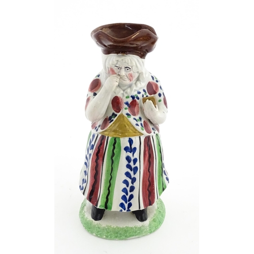80 - A Staffordshire pottery Lady Snuff Taker Toby jug.  Approx. 9 3/4
