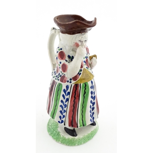 80 - A Staffordshire pottery Lady Snuff Taker Toby jug.  Approx. 9 3/4