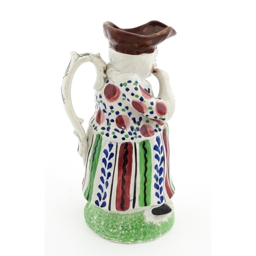 80 - A Staffordshire pottery Lady Snuff Taker Toby jug.  Approx. 9 3/4