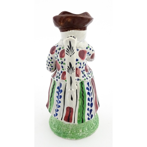 80 - A Staffordshire pottery Lady Snuff Taker Toby jug.  Approx. 9 3/4