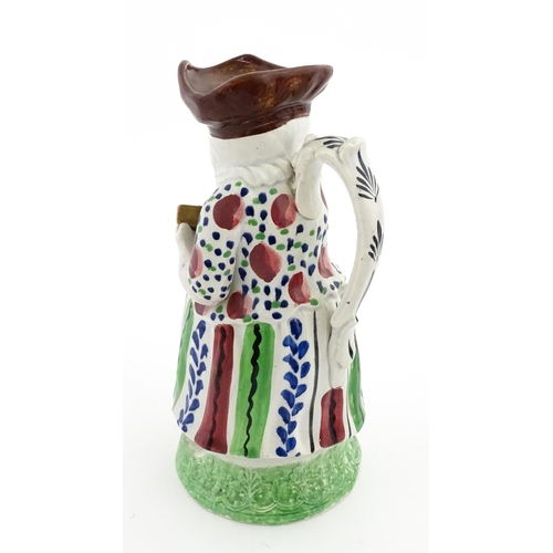 80 - A Staffordshire pottery Lady Snuff Taker Toby jug.  Approx. 9 3/4
