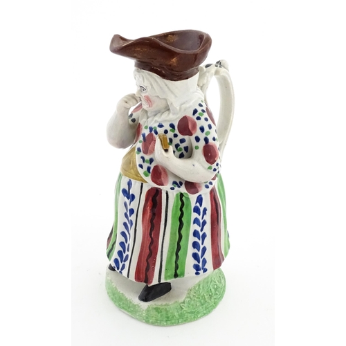 80 - A Staffordshire pottery Lady Snuff Taker Toby jug.  Approx. 9 3/4