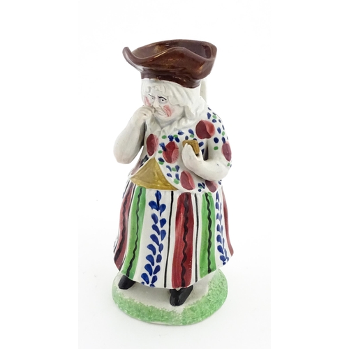 80 - A Staffordshire pottery Lady Snuff Taker Toby jug.  Approx. 9 3/4