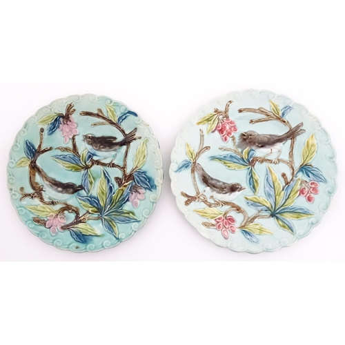 84 - A pair of French majolica plates with relief decoration depicting birds, berries and leaves. Approx.... 